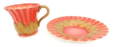 A Royal Worcester porcelain coffee cup and saucer, circa 1934, of fluted and leaf moulded form, shape number 3061, printed Register Applied For, printed marks.