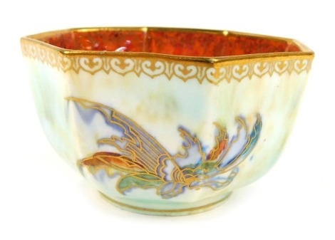 An early 20thC Wedgwood butterfly lustre bowl, of octagonal form, decorated externally with butterflies against a pale blue ground, internally in orange mottled glaze, pattern number Z4832, printed and paints marks, 8.5cm wide.