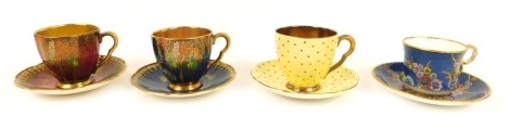 Four Carltonware coffee cups and saucers, comprising a blue ground coffee cup and saucer, decorated with birds and trees, a red ground cup and saucer, similarly decorated, polka dot cup and saucer, and a further coffee cup and saucer, decorated with flowe