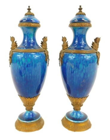 A pair of late 19thC blue glaze pottery vases, of baluster form, with classical brass mounts, 19.5cm high.