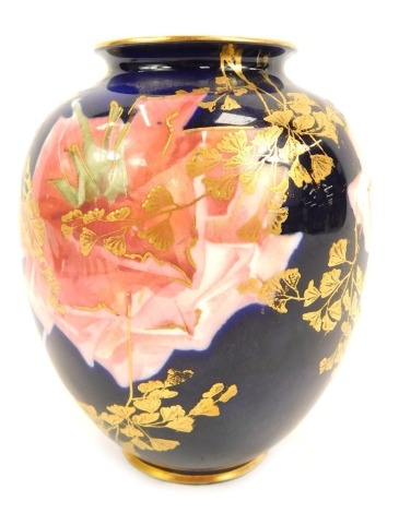 A Royal Doulton porcelain vase, of ovoid form, painted with roses and gilt leaves against a cobalt blue ground, printed and painted marks, 11.5cm high.