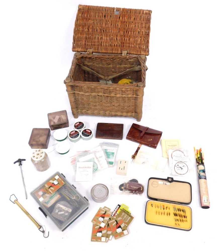 A wicker basket and contents of fly fishing tackle, comprising