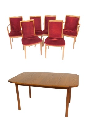 A G Plan teak draw leaf dining table, raised on octagonal legs, 72cm high, 142cm wide, 190cm extended, 98cm deep, together with six teak dining chairs, upholstered in red draylon, comprising a pair of carvers and four single chairs. The upholstery in thi