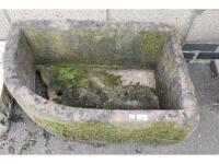 A carved stone quarter water trough