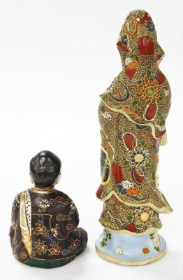 A Japanese Satsuma figure of Kannon, modelled standing holding a scroll, 34cm high, and a further Satsuma figure of a seated Buddha, 14cm high. (2) - 9