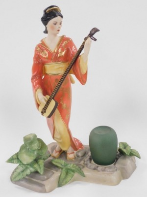 A group of Japanese and Chinese porcelain and pottery, including a Satsuma koro and cover, vase and cover, figure of a Japanese lady playing a samisen, and a Chinese porcelain chocolate cup and cover. (a quantity) - 19