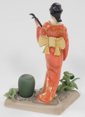 A group of Japanese and Chinese porcelain and pottery, including a Satsuma koro and cover, vase and cover, figure of a Japanese lady playing a samisen, and a Chinese porcelain chocolate cup and cover. (a quantity) - 20