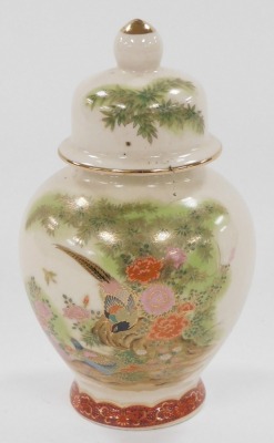 A group of Japanese and Chinese porcelain and pottery, including a Satsuma koro and cover, vase and cover, figure of a Japanese lady playing a samisen, and a Chinese porcelain chocolate cup and cover. (a quantity) - 22