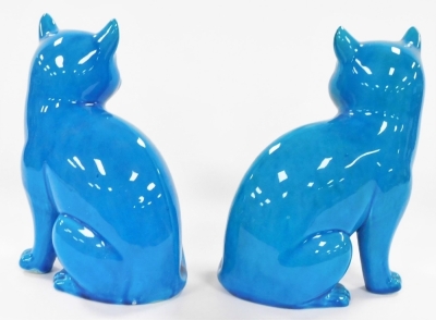 A pair of Chinese turquoise porcelain figures of cats, modelled in seated pose, 16cm wide. (AF) - 6