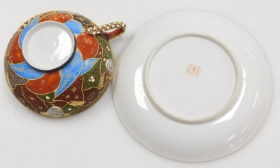 A Taisho period Japanese Kutani porcelain tea set, decorated with dragons in relief and reserves of figures, coral, red and blue decoration on a brown ground, with gilt highlights, comprising, teapot, two handled sucrier, creamer, six cups with geisha lit - 10