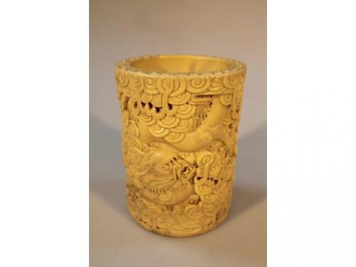 A Chinese relief moulded yellow glazed brush pot with dragon and stylized