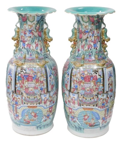 A pair of large 19thC Chinese Canton porcelain vases, of shouldered cylindrical form, with flared necks, twin gilt heightened dog of fo handles and applied dragon motifs, the body of each decorated with a court scene to the front and naval battles to the 