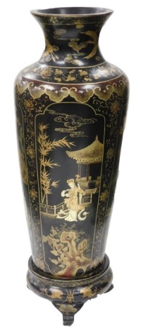 A 19thC Japanese black lacquer floor standing vase, of shouldered cylindrical tapering form, decorated with reserves of women in interior and exterior scenes, surrounded by a background of gilt flowering plants, on a tripod painted wooden stand, 113cm hig