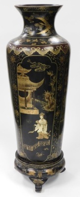 A 19thC Japanese black lacquer floor standing vase, of shouldered cylindrical tapering form, decorated with reserves of women in interior and exterior scenes, surrounded by a background of gilt flowering plants, on a tripod painted wooden stand, 113cm hig - 4