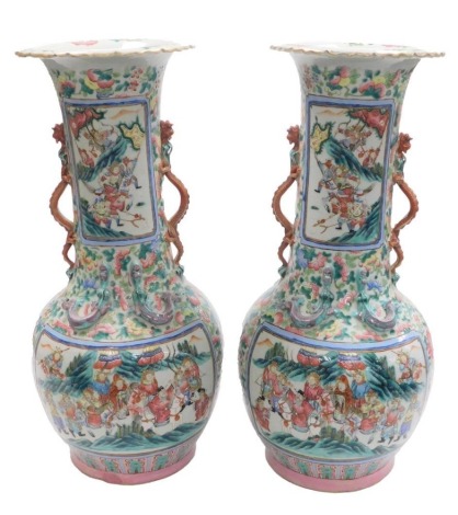 A pair of Chinese associated Canton vases, of bottle form with elongated neck and flared rim, decorated with applied dragons, and reserves painted with figures on horseback and battle scenes, against a famille rose palette, unmarked, 58cm high.