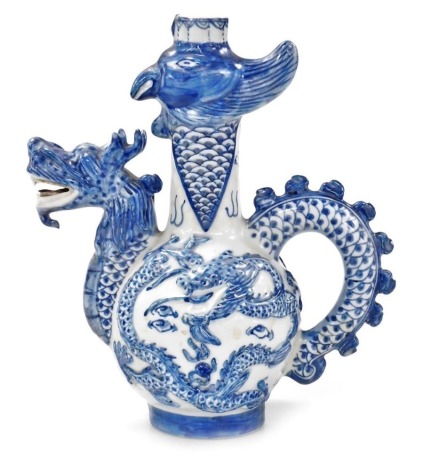 A 20thC Chinese blue and white bottle jug, with a dragon's head spout and tail handle, the bottle with a bird's head, moulded body with dragons and flaming pearls, Jiaqing seal mark to base, 43cm high.