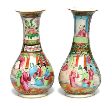 A pair of 19thC Chinese porcelain famille rose vases, of bottle form with flared necks, decorated with reserves of figures in interior scenes and to the reverse a bird on a flowering branch, unmarked, 16cm high.