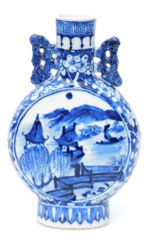 A Chinese blue and white porcelain moon flask, decorated to both sides with panels of buildings in landscapes, within a floral background, unmarked, 23cm high.