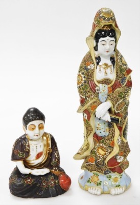 A Japanese Satsuma figure of Kannon, modelled standing holding a scroll, 34cm high, and a further Satsuma figure of a seated Buddha, 14cm high. (2)