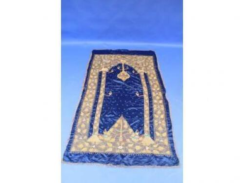 An Arabic silk prayer rug decorated in gold braid with birds and flowers