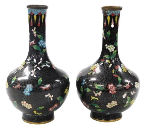 A pair of 20thC Chinese cloisonne enamel vases, of baluster form, decorated with blossom within a black ground, stamped Made in China, 24cm high.