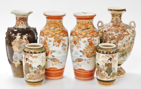 A group of early 20thC Japanese Kutani and Satsuma pottery, comprising a pair of Kutani vases, decorated with reserves of mandarin ducks and geese, 37cm high, pair of Satsuma vases decorated with figures in a garden, 18cm high, and two single Satsuma vase