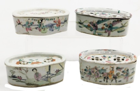 Four Chinese famille rose porcelain cricket boxes and covers, circa 1900, of oblong form, painted with figures, flowers, and Chinese characters.