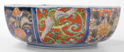 A 20thC Japanese Imari bowl, of octagonal form, decorated with panels of exotic birds, dragons, and flowers, four character mark, 23cm wide.