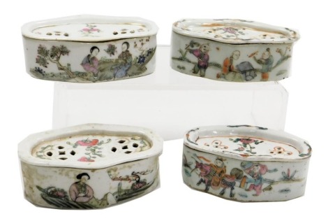 Four Chinese famille rose porcelain cricket boxes and covers, circa 1900, of oblong form, painted with figures, flowers, and Chinese characters.