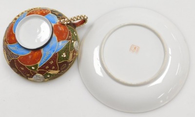 A Taisho period Japanese Kutani porcelain tea set, decorated with dragons in relief and reserves of figures, coral, red and blue decoration on a brown ground, with gilt highlights, comprising, teapot, two handled sucrier, creamer, six cups with geisha lit - 3