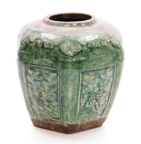 A Chinese green glazed hexagonal pottery jar, with rectangular low relief floral panels, 19thC, 16cm high.