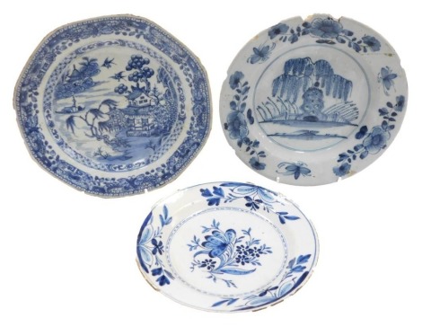 A late 18thC Dutch Delft blue and white charger, with flowers and branches, 20cm diameter (AF), together with a mid-18thC English porcelain charger, depicting bridges and trees with flower and bird bordering, 22.5cm wide (AF), and a Chinese blue and white