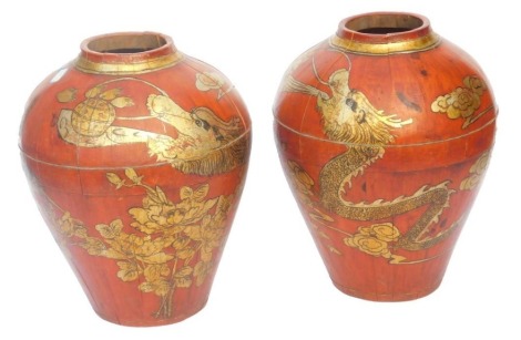 A pair of Chinese red and gilt lacquered wooden vases, of shouldered tapering form, decorated with dragons and hoho birds, 42cm high.