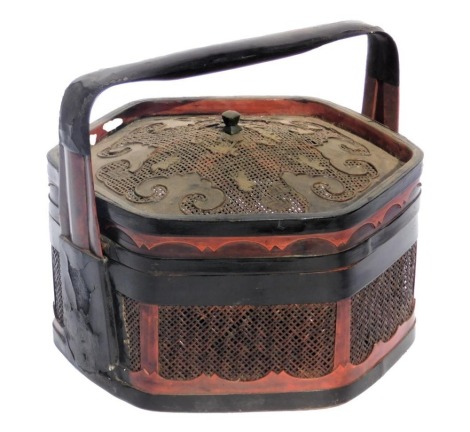 A Chinese black and red lacquer food container, of hexagonal form, with a cane work lid, and cane sides, 35cm wide.