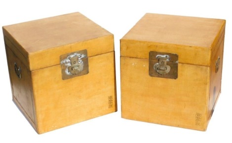 A pair of Chinese yellow lacquer chests, of square section, with twin carrying handles, each 40cm high, 40cm wide, 40cm deep.