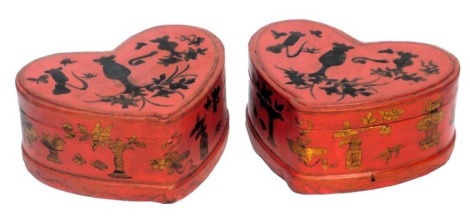 A pair of Chinese red and gilt lacquer boxes of heart shaped form, decorated in relief with vases of blossom, 31.5cm wide.