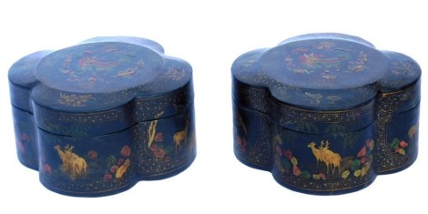 A pair of Chinese black and polychrome decorated lacquer boxes, of quatrefoil form, decorated with panels of dragons, Buddhist emblems, and animals, 28.5cm wide.