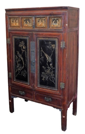 A Chinese red and black lacquer cabinet, with gilt fret work carved panels, over two aesthetic carved doors, 173cm high, 103cm wide, 52cm deep.