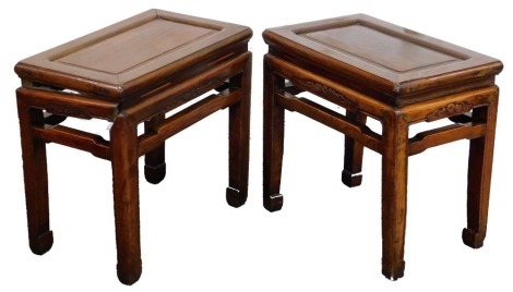 A pair of Chinese hardwood tables, with bat carved friezes, 49cm high, 53cm wide, 34cm deep.