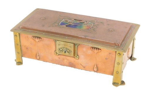 An early 20thC Arts and Crafts copper brass and enamel box, with enamel lid, sectional interior, embossed floral motifs, on brass feet, 8cm high, 22cm wide, 10cm deep.