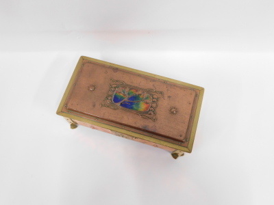 An early 20thC Arts and Crafts copper brass and enamel box, with enamel lid, sectional interior, embossed floral motifs, on brass feet, 8cm high, 22cm wide, 10cm deep. - 2