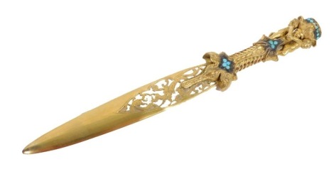 A 19thC gilt metal paper knife, the handle with cherub pommel set with a compressed green stone, with pierced blade, 22cm long.