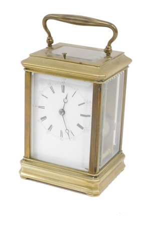 A late 19thC brass repeating carriage clock, with 7cm wide Roman numeric and Arabic dial, on compressed feet, with barrel movement, minute repeating, with key, 17cm high.