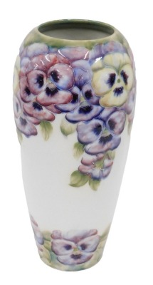 An early 20thC Macintyre Moorcroft pottery pansies pattern vase, on white ground, printed and script mark beneath, 32cm high. (AF)