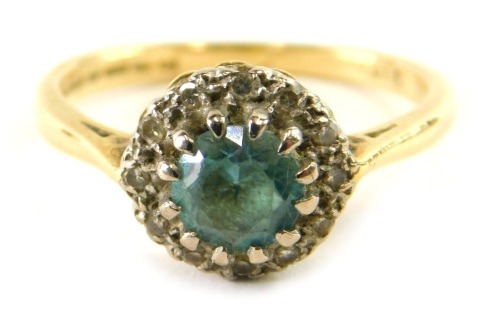 An 18ct gold diamond and aquamarine set dress ring, size K, 3g all in.