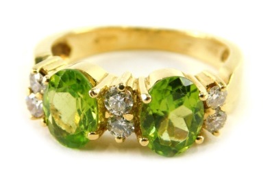 An 18ct gold, peridot and diamond set dress ring, size P, 6.3g all in.