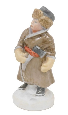 A mid 20thC Pesochnoye Moscow bisque porcelain figure of a boy, with hatchet, marked beneath, 22cm high.