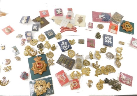 Various brass cap badges, plated and others, some originals, a Gloucestershire shoulder title badge, other medal cap badges, 37 North Hampshire Regiment, 52cm high, etc., various others, a large quantity of other cap badges to include original and reprodu