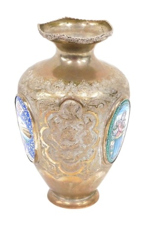 An Indian vase, profusely decorated with a repeat floral pattern broken by oval enamel medallions, on a circular foot, white metal, marked beneath, 19cm high.