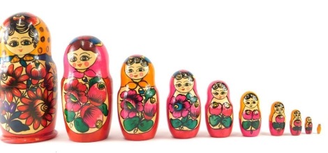 A wooden set of Russian dolls, each vibrantly decorated with flowers, 25cm high.